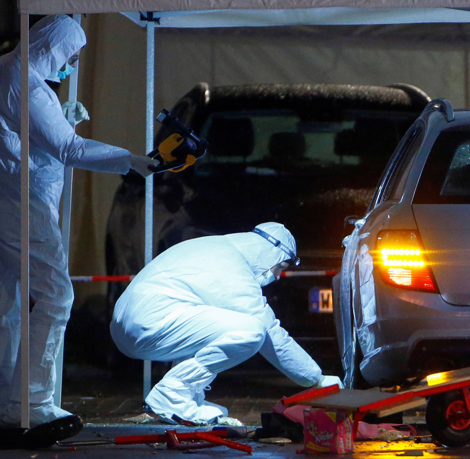 Police forensic officers work at the scene after a car ploughed into a carnival parade injuring several people in Volkmarsen