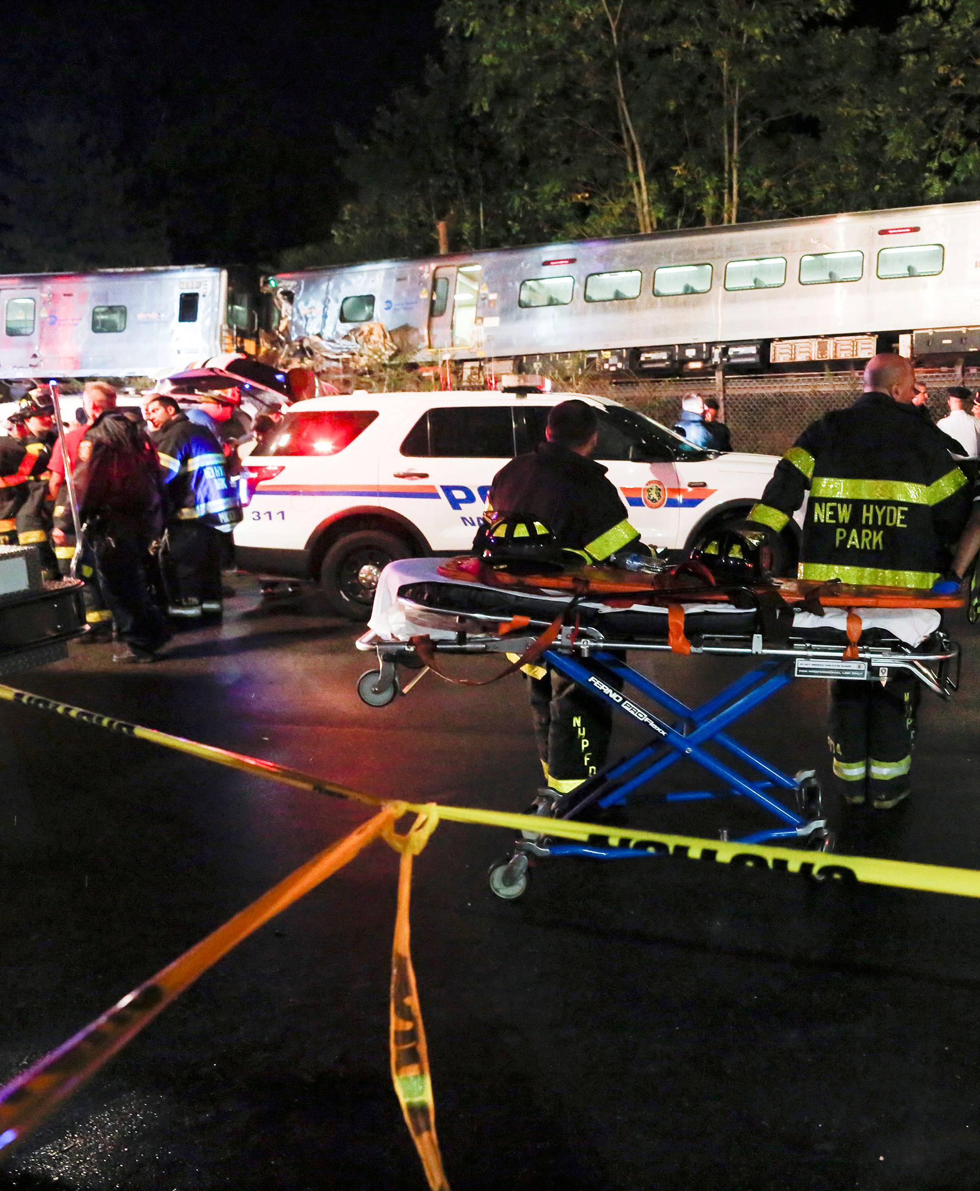 Emergency responders attend to a call of a train derailed near the community of New Hyde Park on Long Island in New York