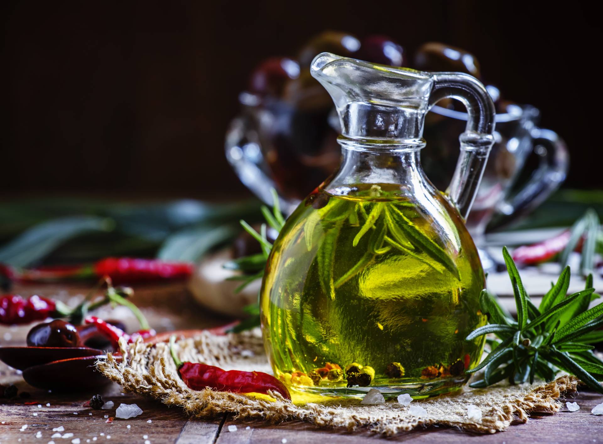 Olive oil with rosemary and spices in a glass jug
