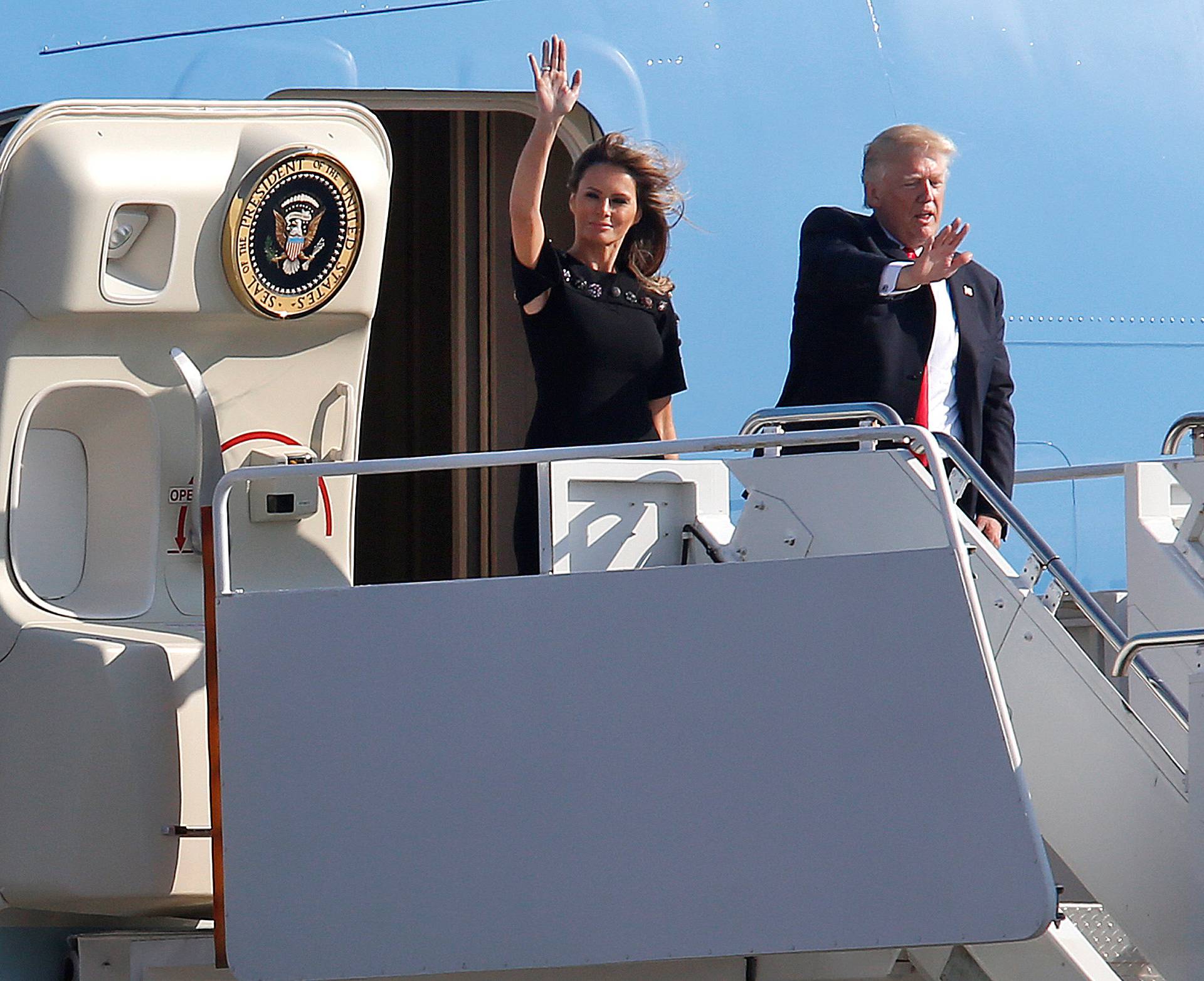 U.S. President Donald Trump and first lady Melania Trump wave outside Air Force One before returning to Washington D.C. at Sigonella Air Force Base in Sigonella, Sicily