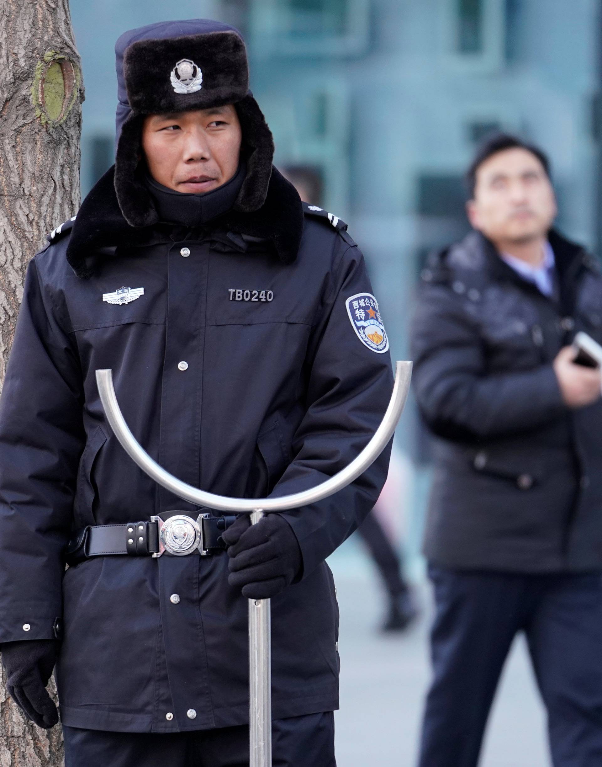 Security personnel stand guard outside the Joy City Mall in the Xidan district after a knife attack, in Beijing