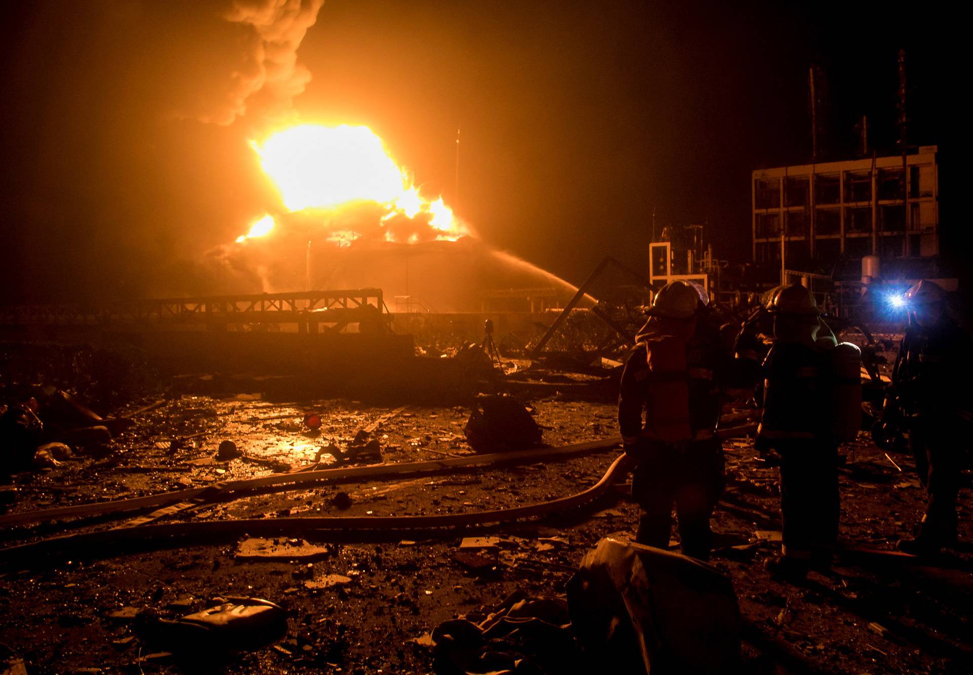 Firefighters work on extinguishing the fire following an explosion at the pesticide plant owned by Tianjiayi Chemical, in Xiangshui