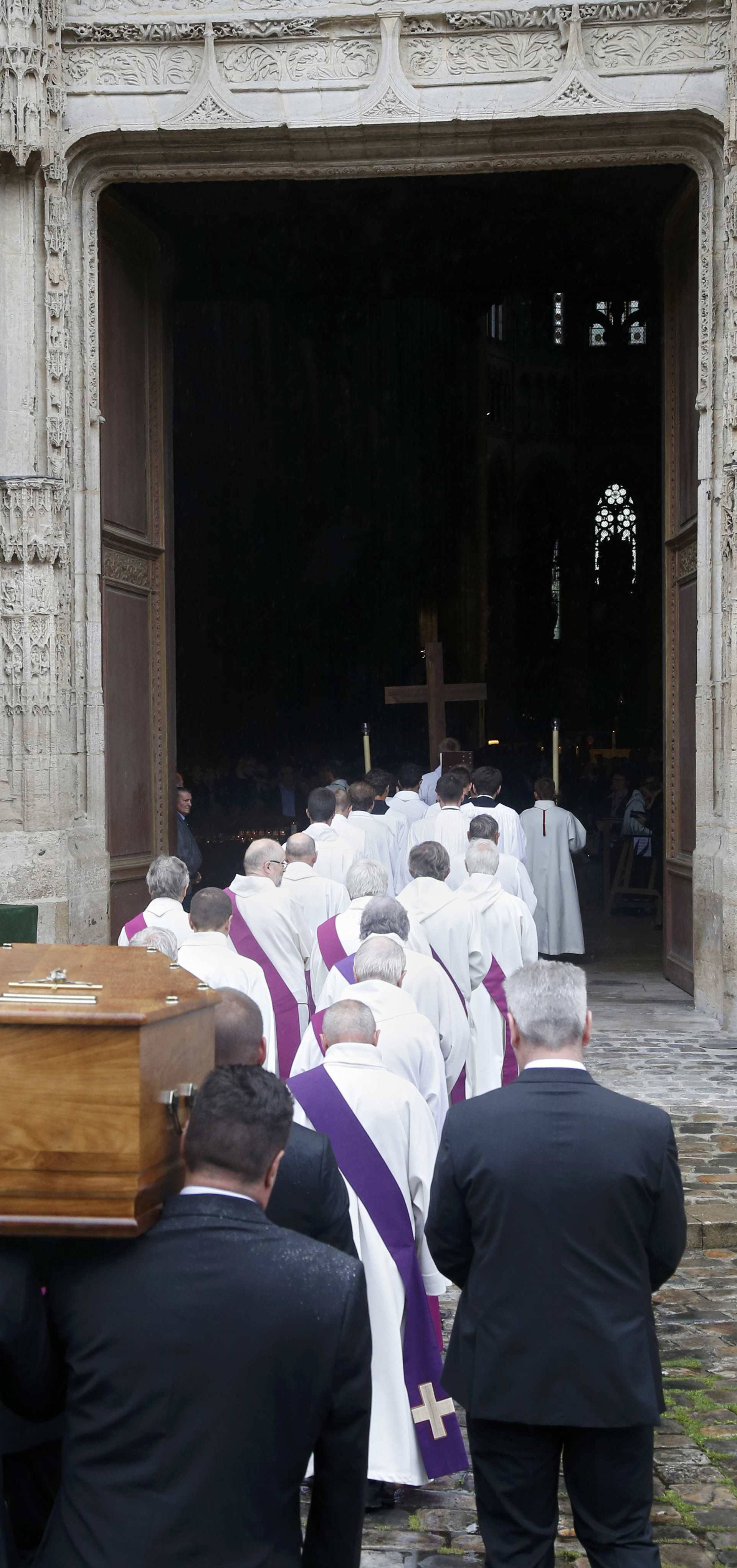 Pallbearers carry the coffin of French parish priest Father Jacques Hamel outside the Cathedral in Rouen