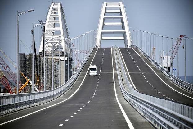 A vehicle drives along a bridge, which was constructed to connect the Russian mainland with the Crimean Peninsula across the Kerch Strait