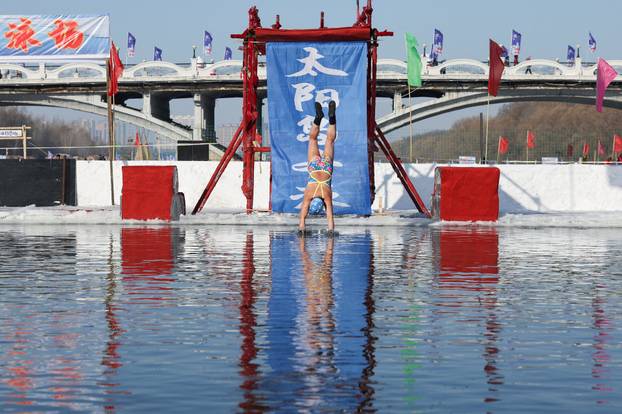 Locals participate in the annual ice and snow sculpture festival, in Harbin