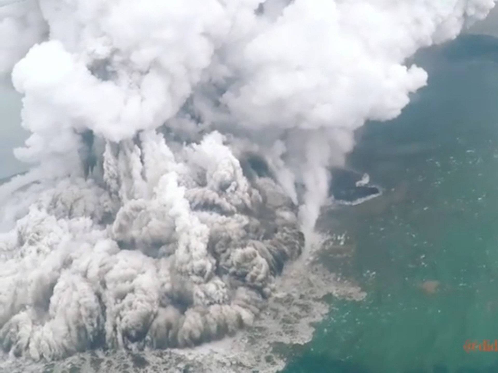 A plume of ash rises as Anak Krakatau erupts in Indonesia