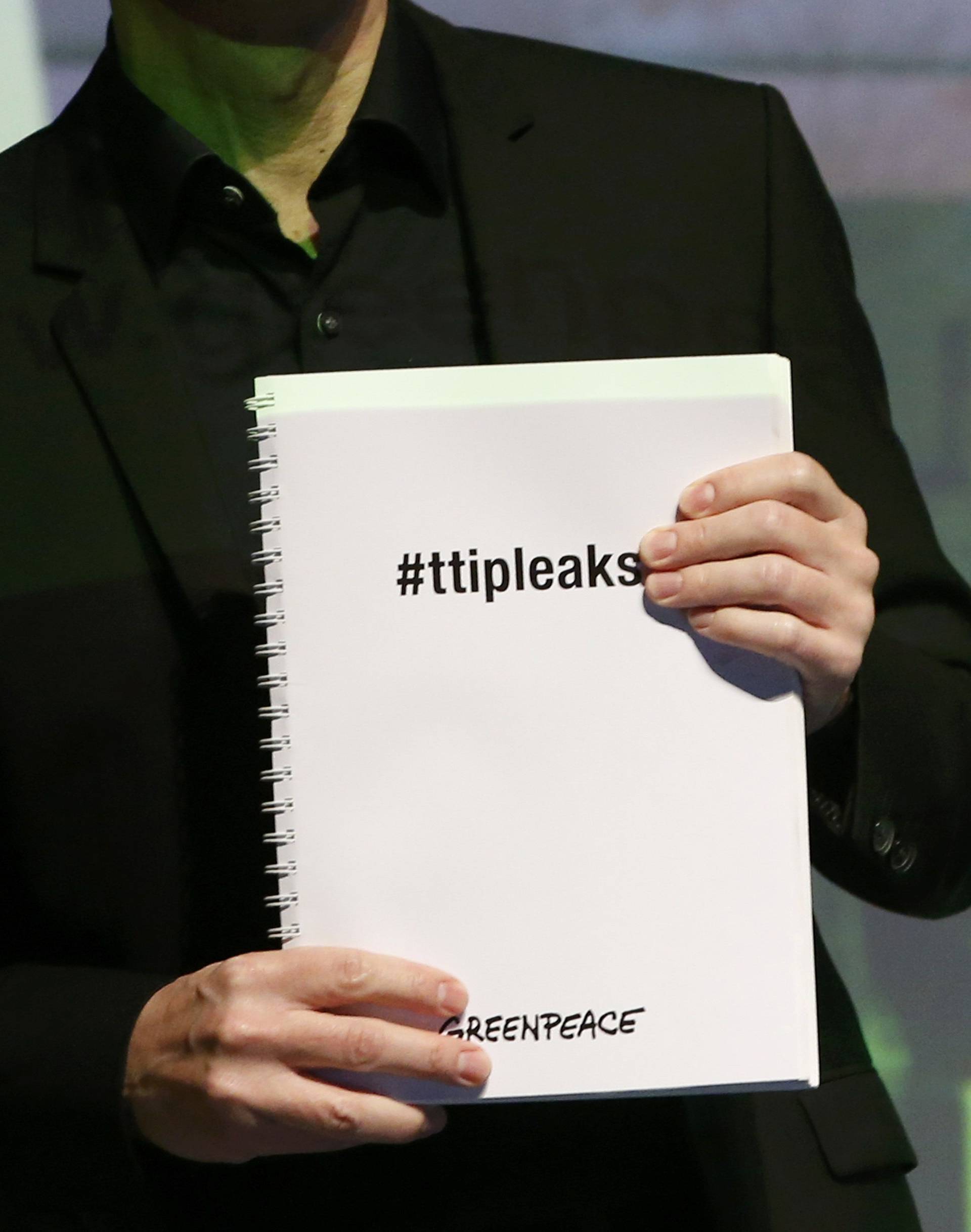 Gassner of Greenpeace holds a copy of the leaked TTIP negotiations in Berlin 