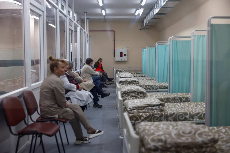 Employees sit inside a part of a hospital situated in an underground shelter in Kherson