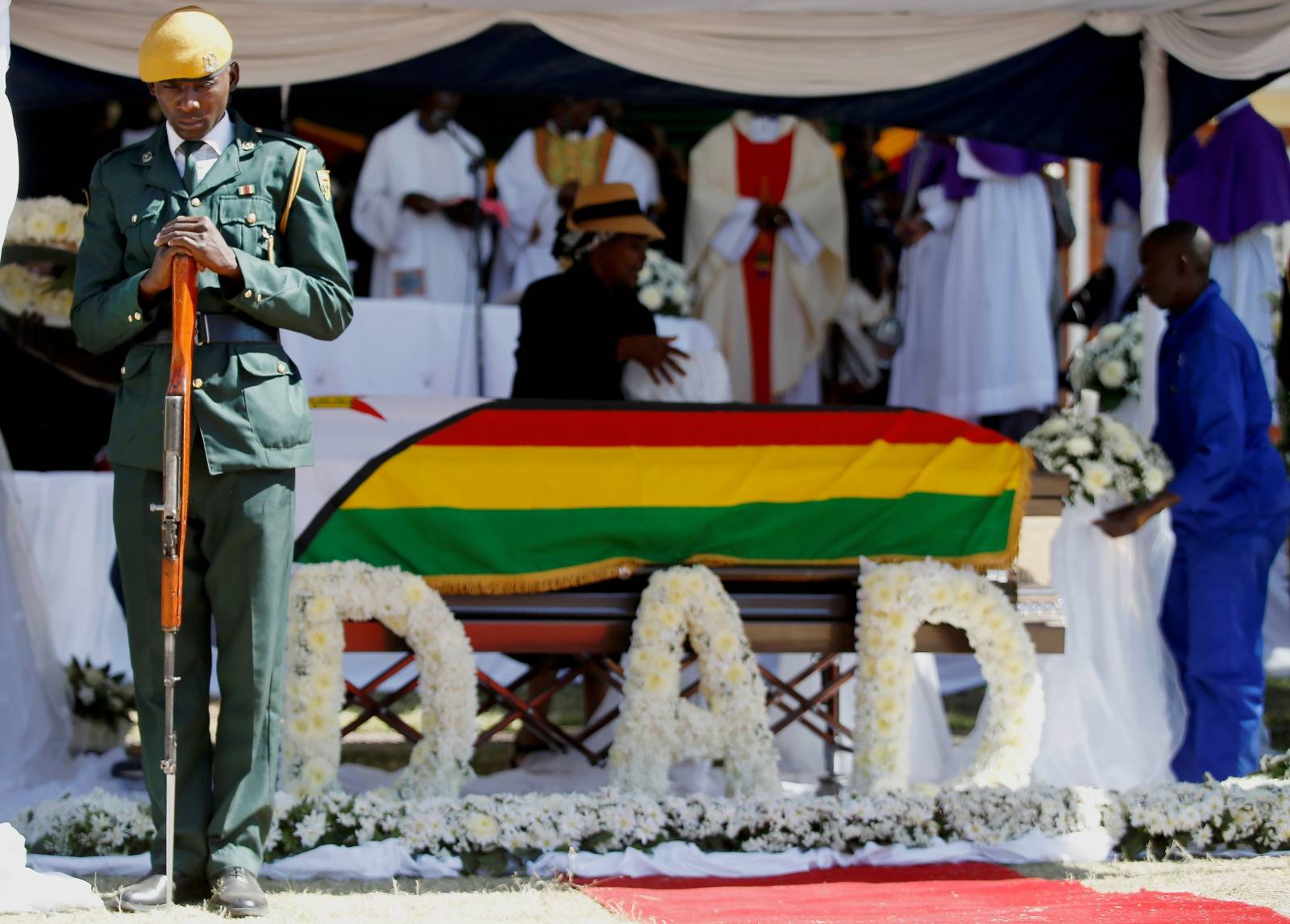 Soldier stands over the coffin of former Zimbabwean President Robert Mugabe during a church service at his rural village in Kutama, Zimbabwe