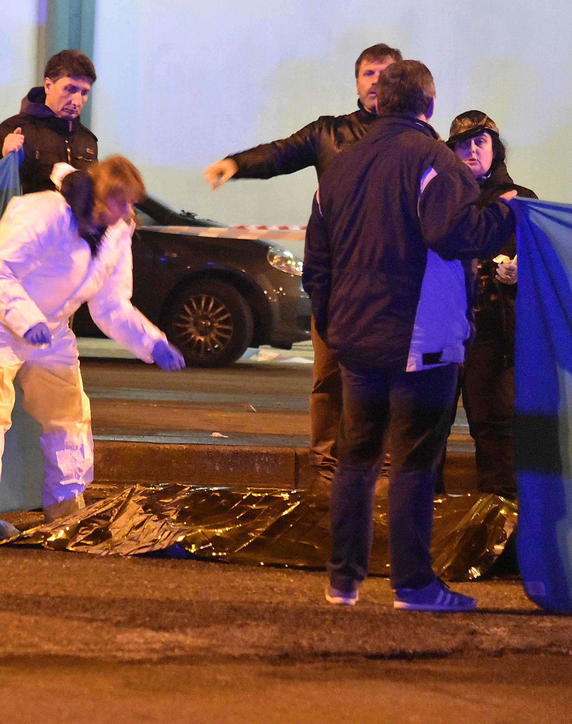 Italian Police officers work next to the body of Anis Amri, the suspect in the Berlin Christmas market truck attack, in a suburb of the northern Italian city of Milan