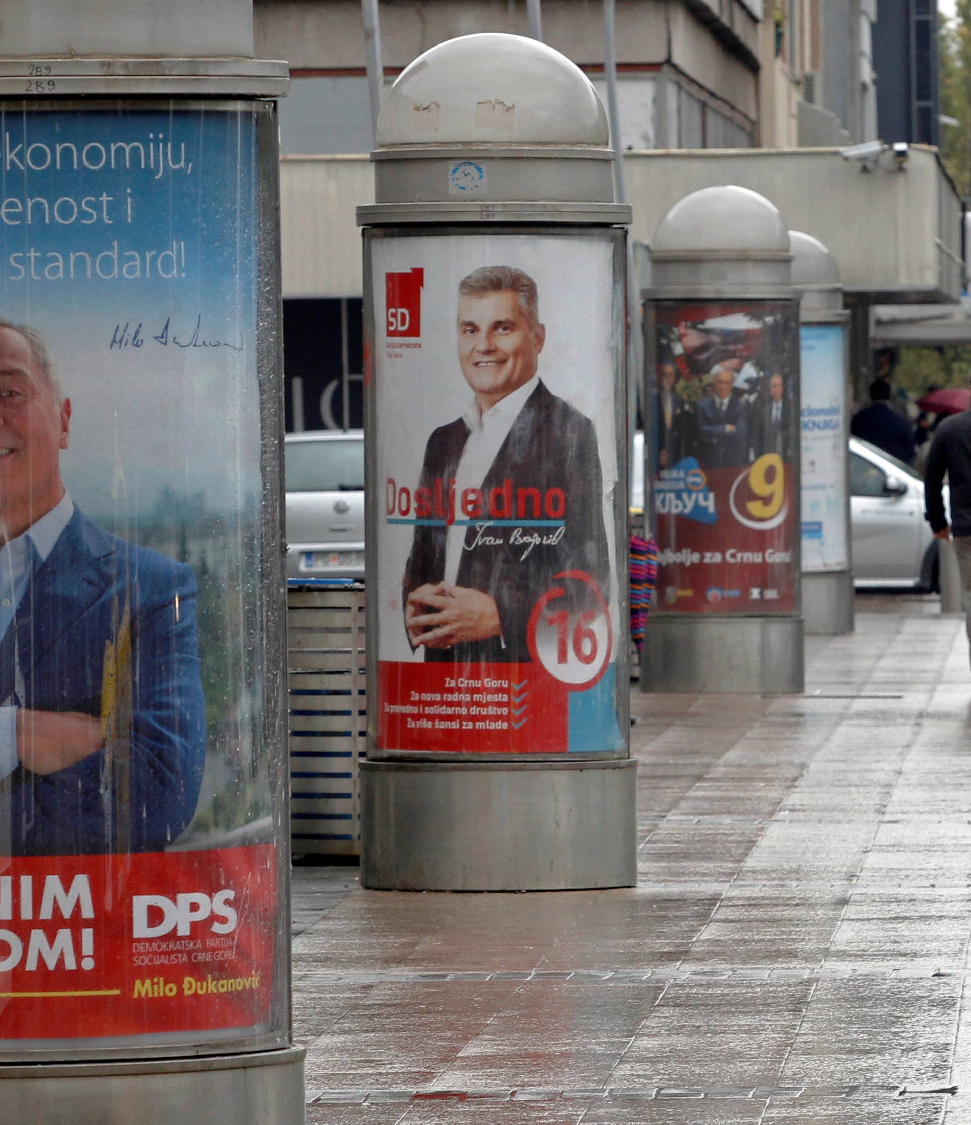 A man walks past election posters ahead of the parliamentary elections in Podgorica
