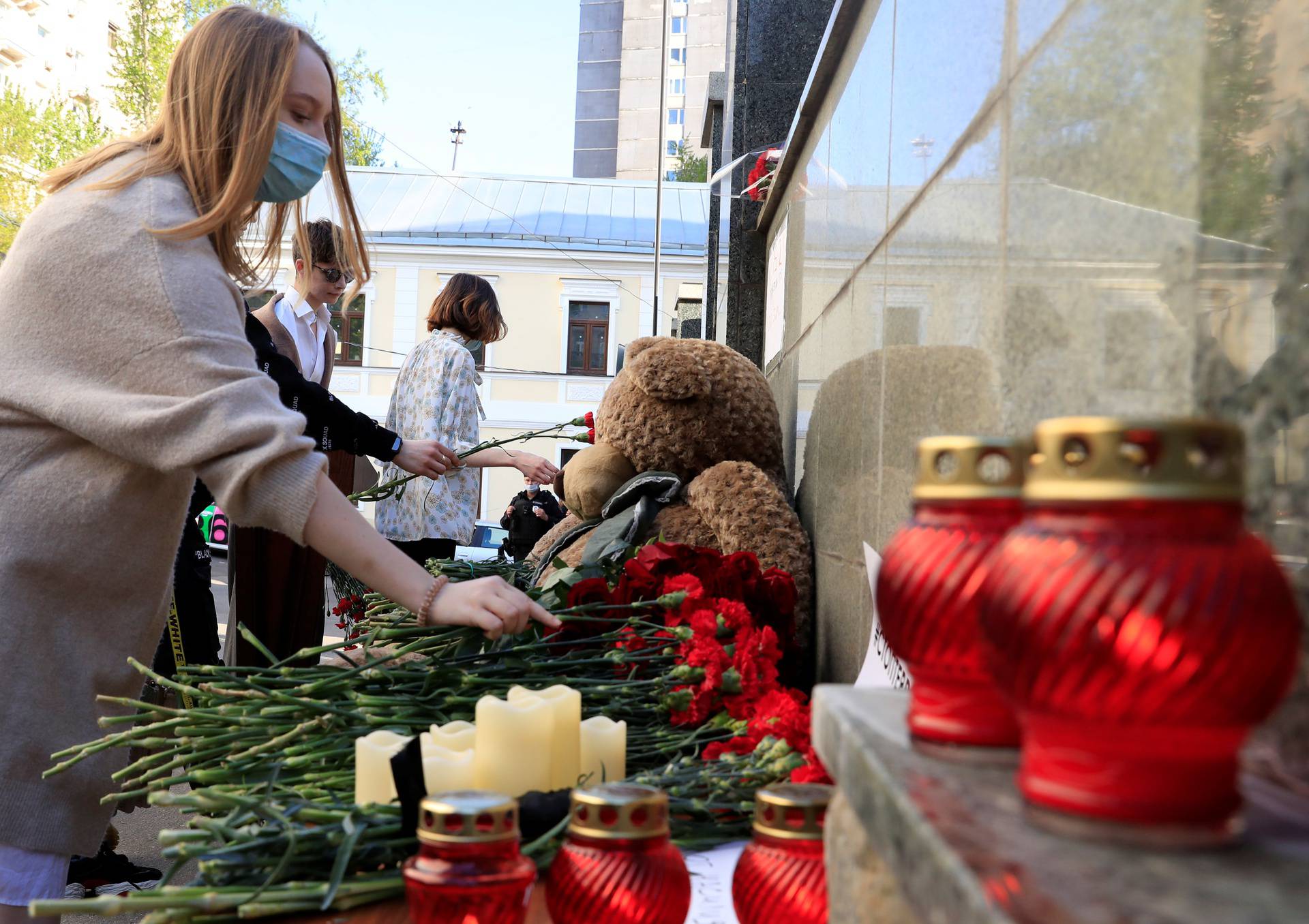 People lay flowers at a makeshift memorial outside the representative office of the Republic of Tatarstan in Moscow