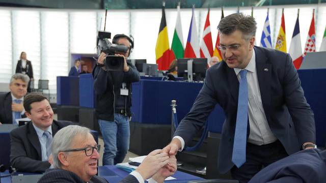 Croatia's Prime Minister Plenkovic shakes hands with European Commission President Juncker as he arrives to deliver a speech during a debate on the Future of Europe at the European Parliament in Strasbourg