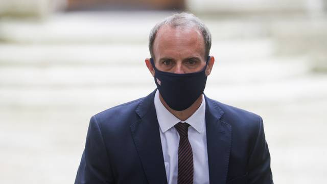 Britain’s Foreign Secretary Dominic Raab walks outside Downing Street, in London