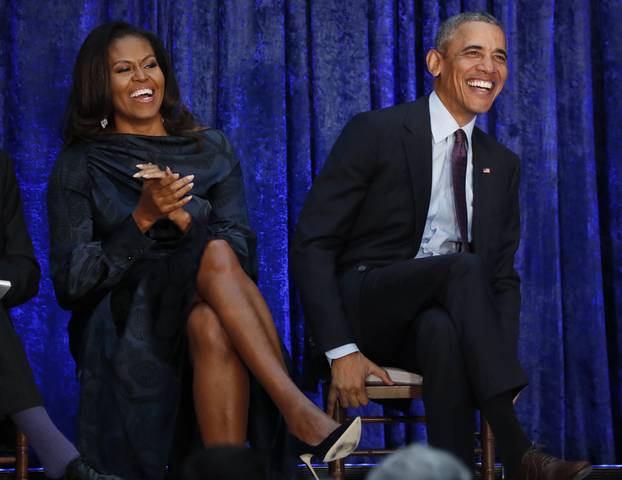 Former U.S. President Obama and first lady Michelle Obama sit together prior to portraits unveiling at the Smithsonianâs National Portrait Gallery in Washington