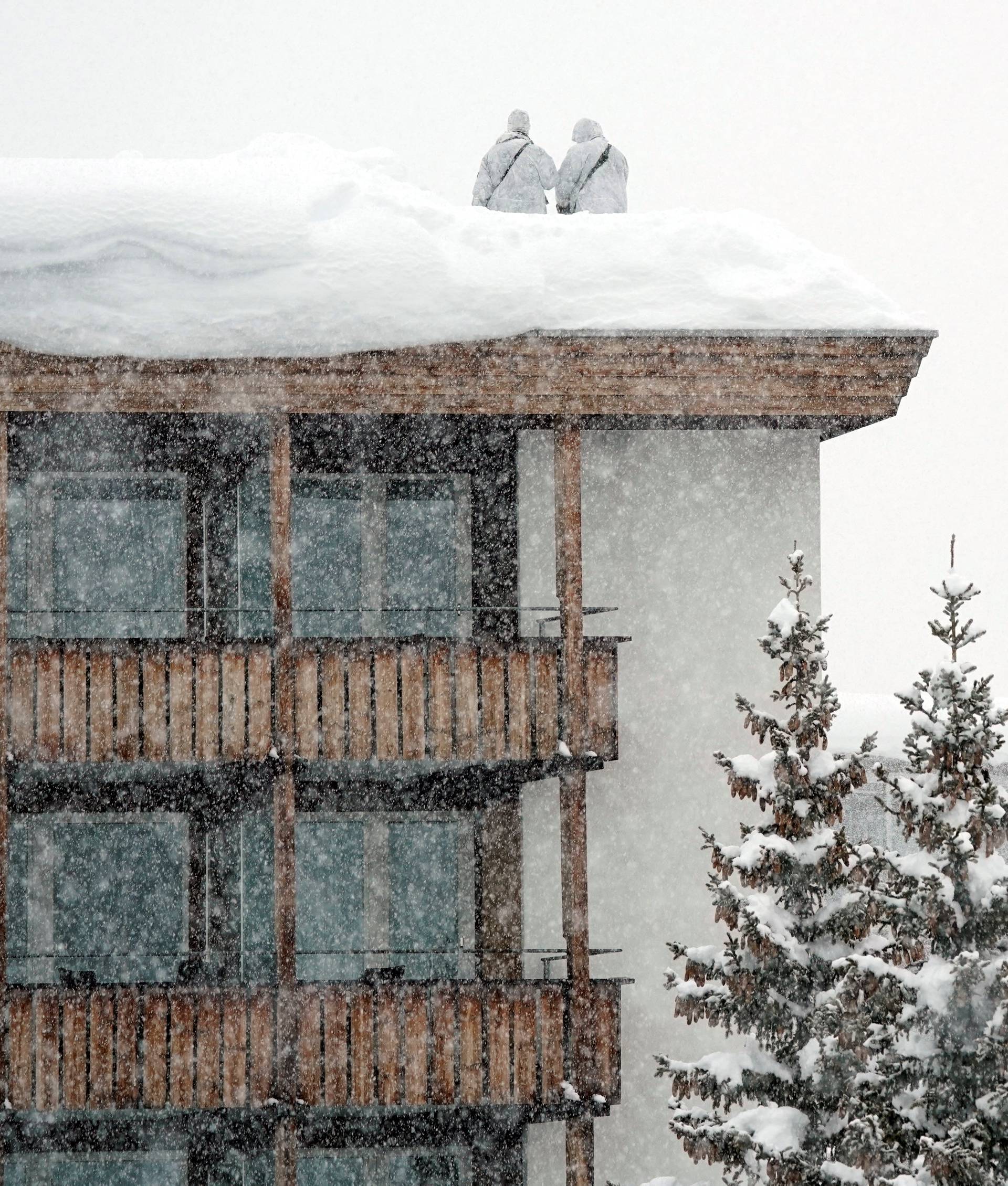 Snipers hold their position on the roof of a hotel during the WEF annual meeting in Davos