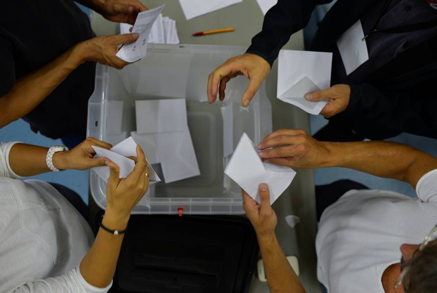 Poll workers count ballots after polls closed in the banned independence referendum in Vic