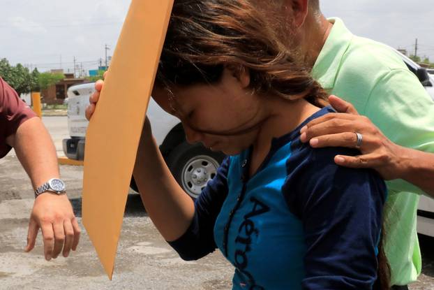 Tania Avalos, wife of a migrant who drowned in the Rio Grande river with his daughter during their journey to the U.S., is seen outside the morgue in Matamoros