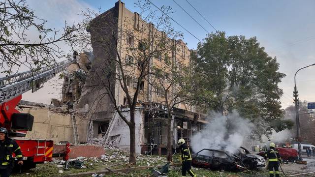 Emergency members work in the aftermath of a Russian military strike in the location given as Cherkasy