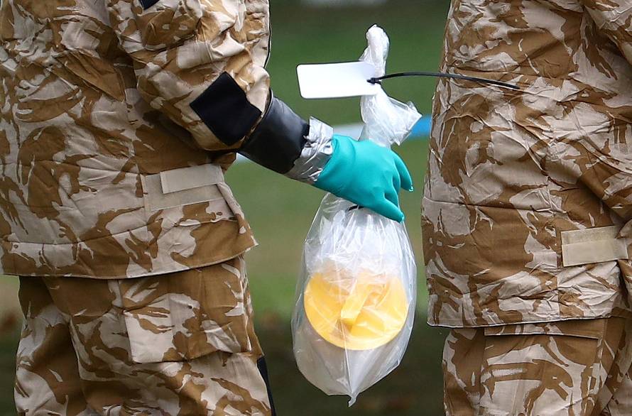 FILE PHOTO: People in military hazardous material protective suits collect an item in Queen Elizabeth Gardens in Salisbury