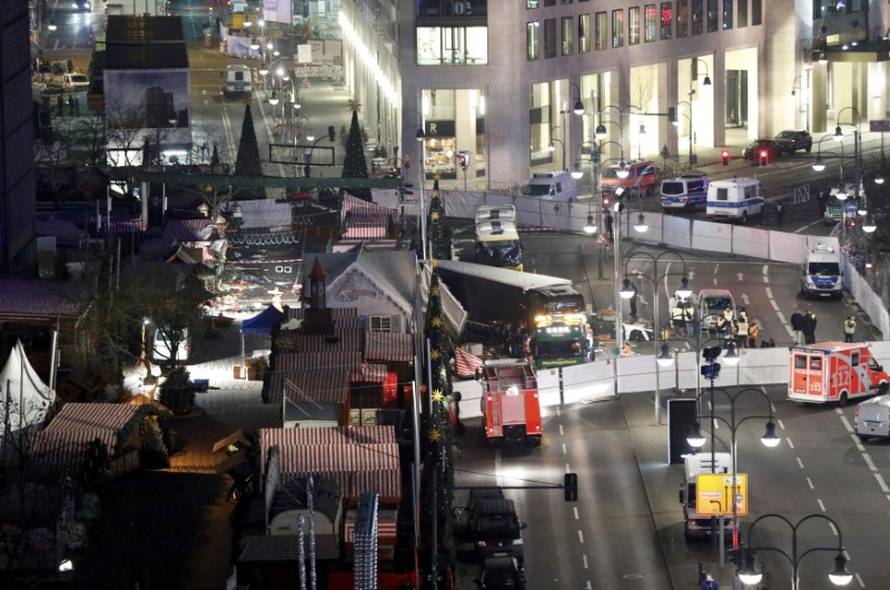 A tow truck operates at the scene where a truck ploughed through a crowd at a Berlin Christmas market