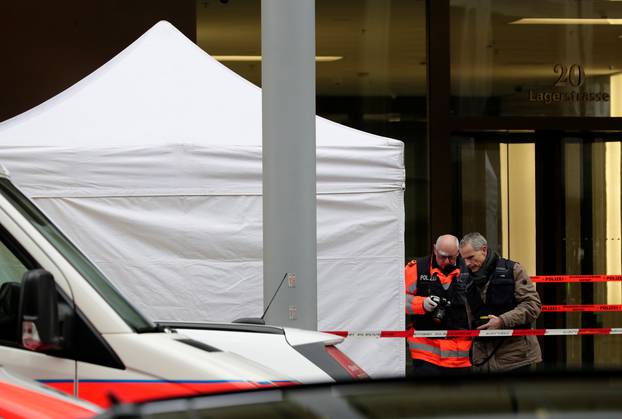 Police investigate a crime scene after two people, police said, were killed in Zurich