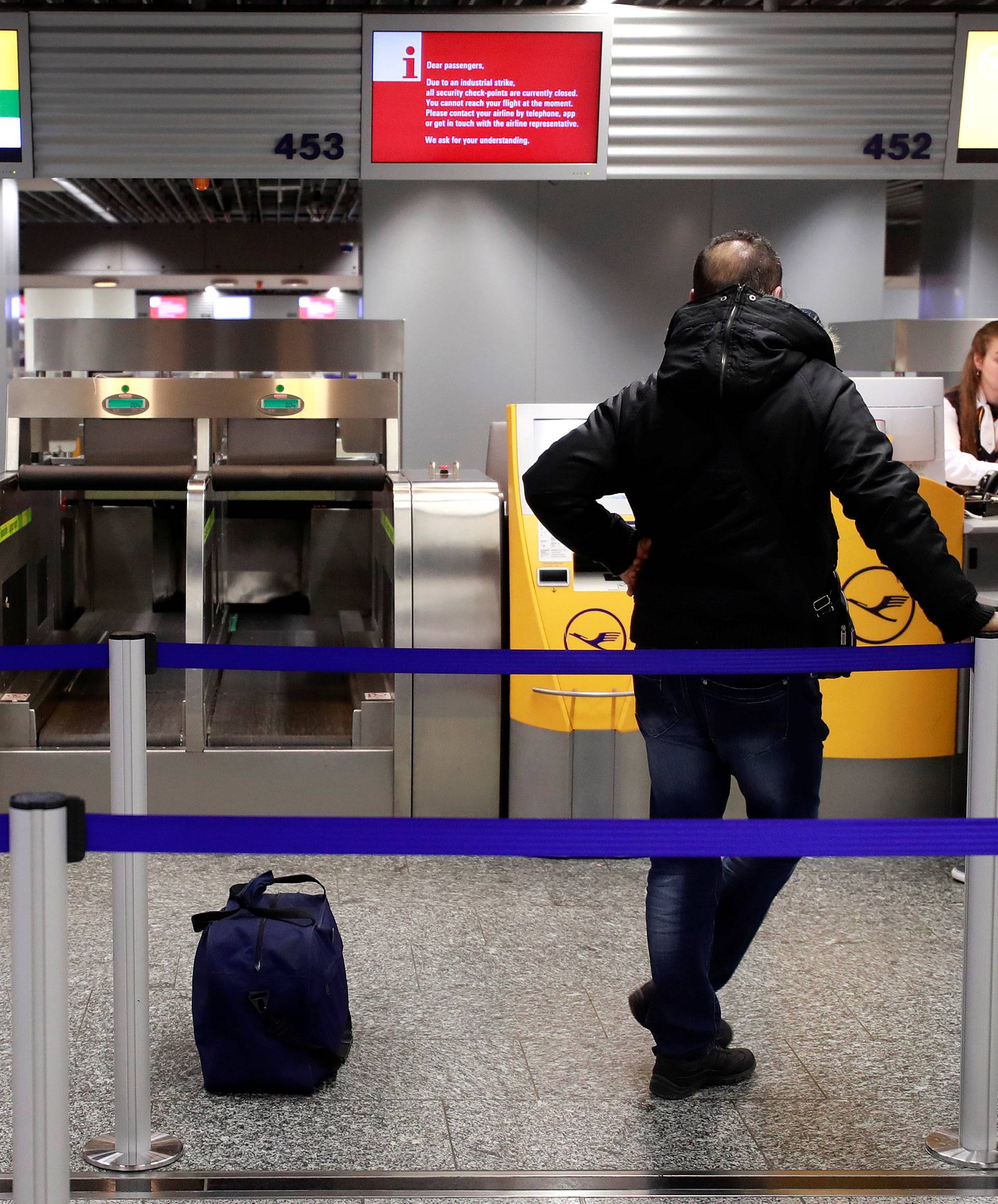 Stranded passenger get information at a check-in desk of German airline Lufthansa during a strike of security personnel over higher wages at Germany's largest airport in Frankfurt