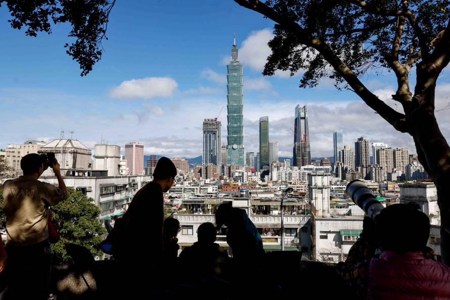 People gather to watch climber Alex Honnold free soloing Taipei 101 Skyscraper in Taipei