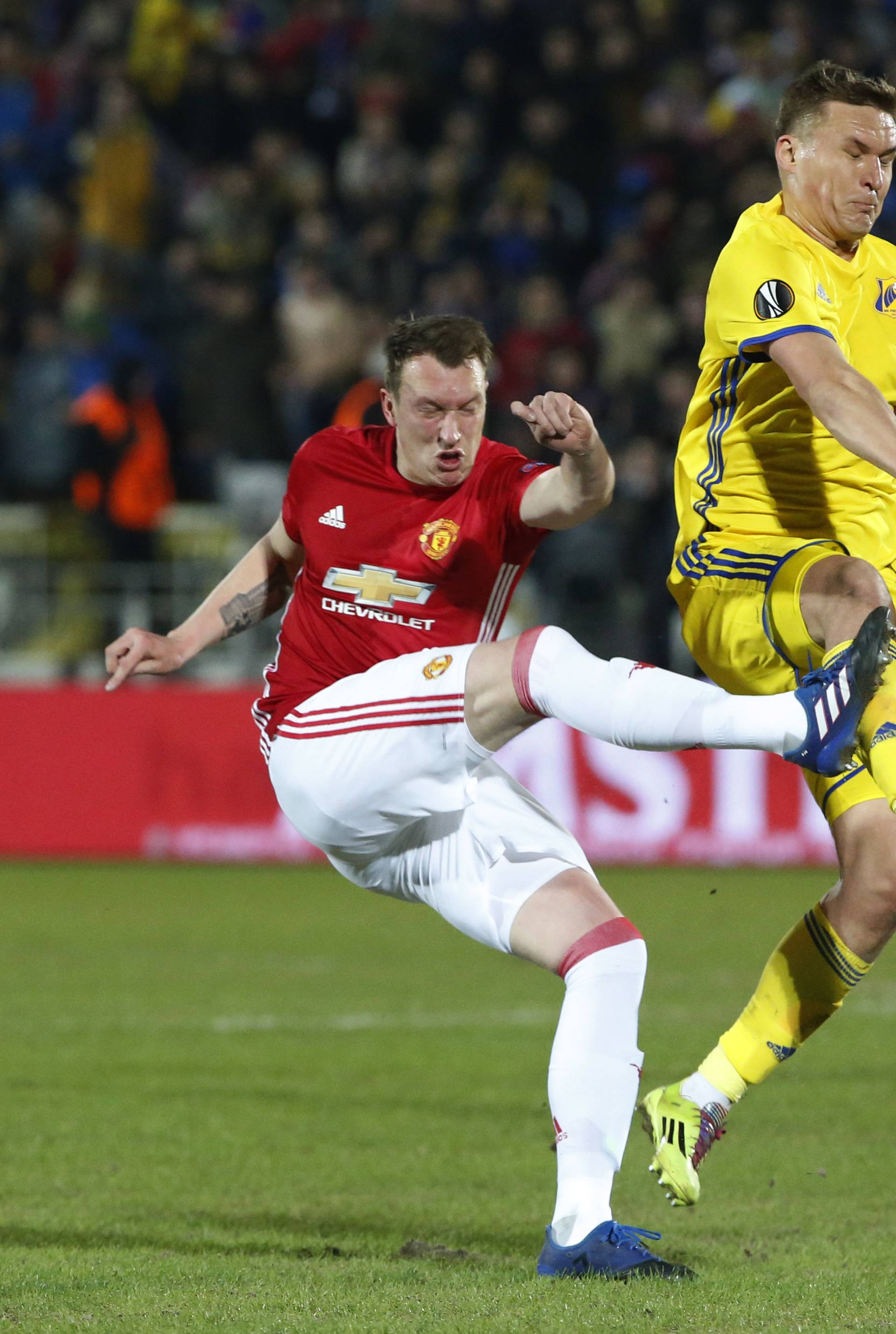 FC Rostov's Aleksandr Bukharov in action with Manchester United's Phil Jones