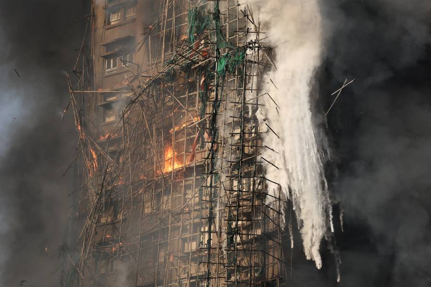 Flames engulf bamboo scaffolding across multiple buildings at Wang Fuk Court housing estate, in Tai Po