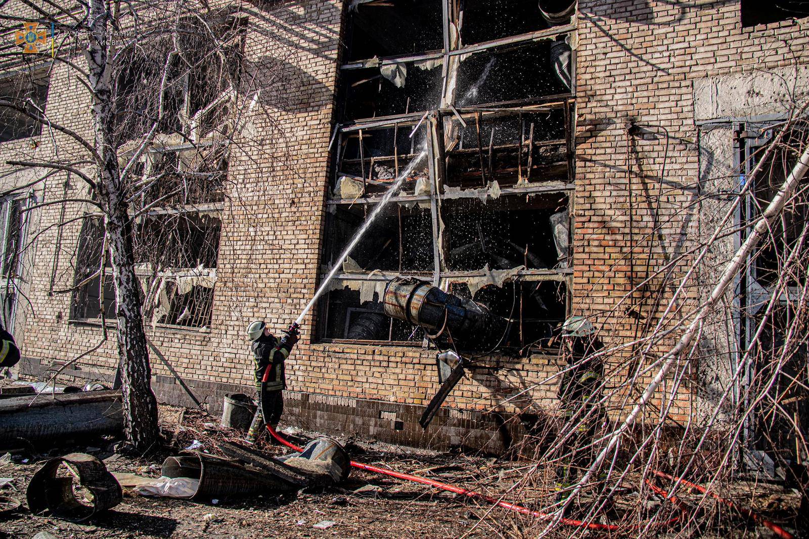 A rescuer works at a site of an industrial building damaged by an airstrike in Kyiv