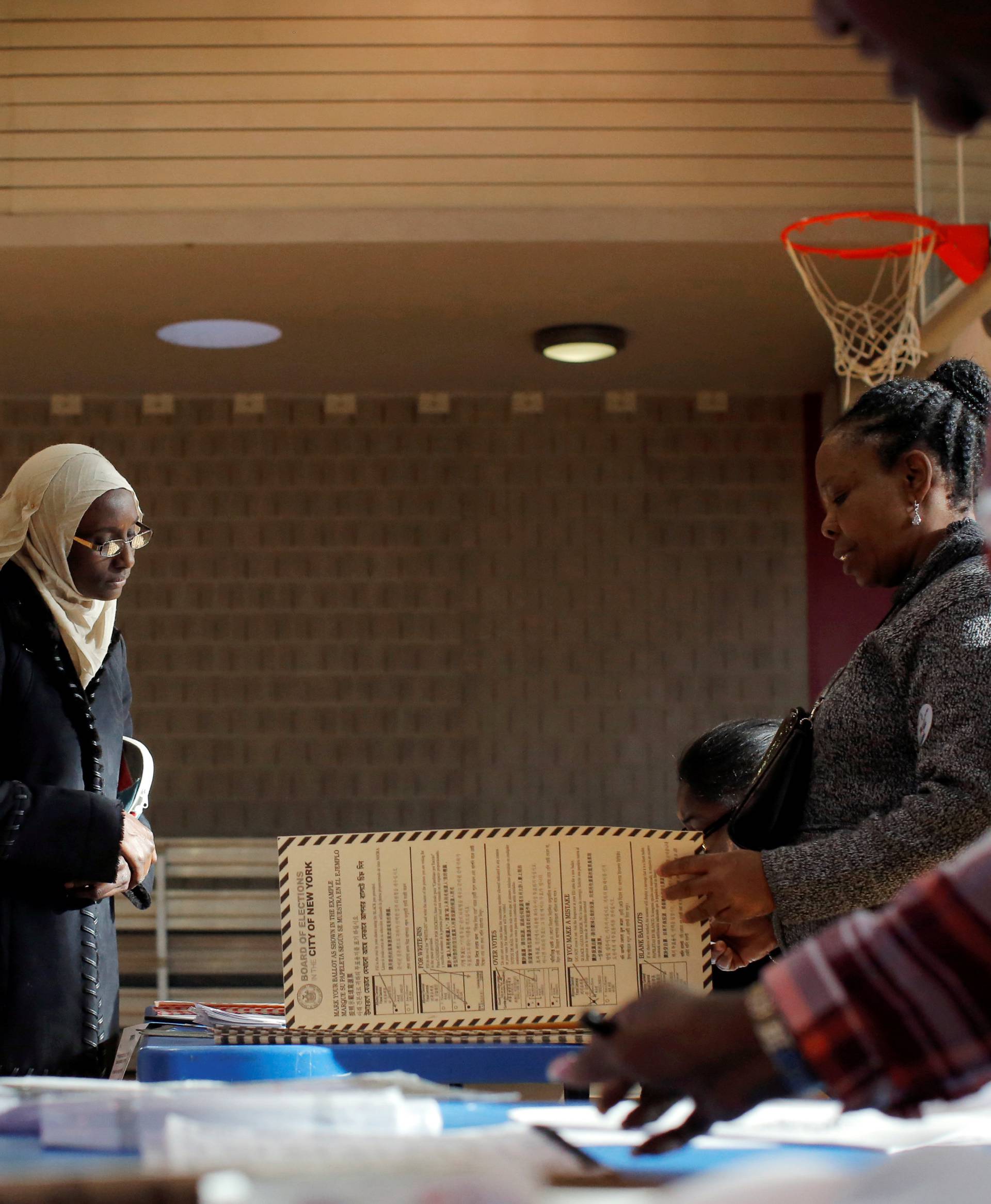 A woman arrives for her voting ballot during the U.S presidential election at the James Weldon Johnson Community Centre in the East Harlem neighbourhood of Manhattan, New York