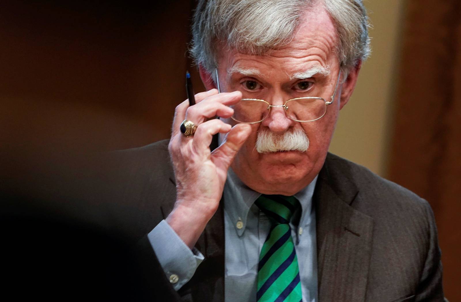 National Security Advisor Bolton listens as U.S. President Trump speaks while meeting with NATO Secretary General Stoltenberg at White House in Washington