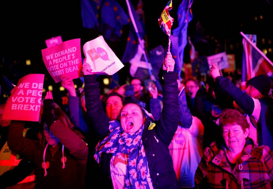 Protesters react after the result was announced on Prime Minister Theresa May's Brexit deal in London