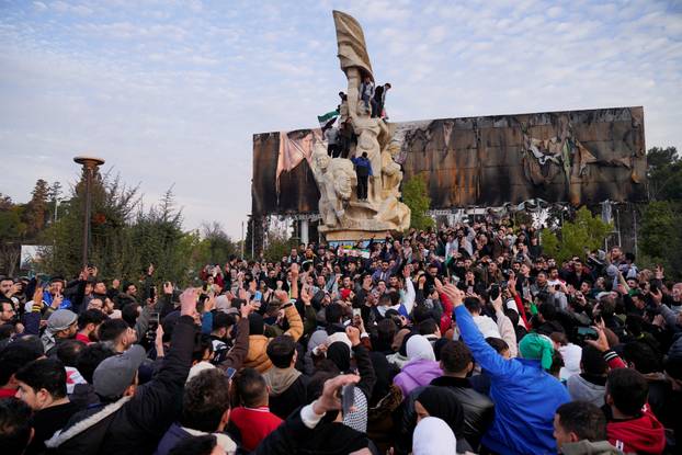 People gather at Saadallah al-Jabiri Square as they celebrate, in Aleppo