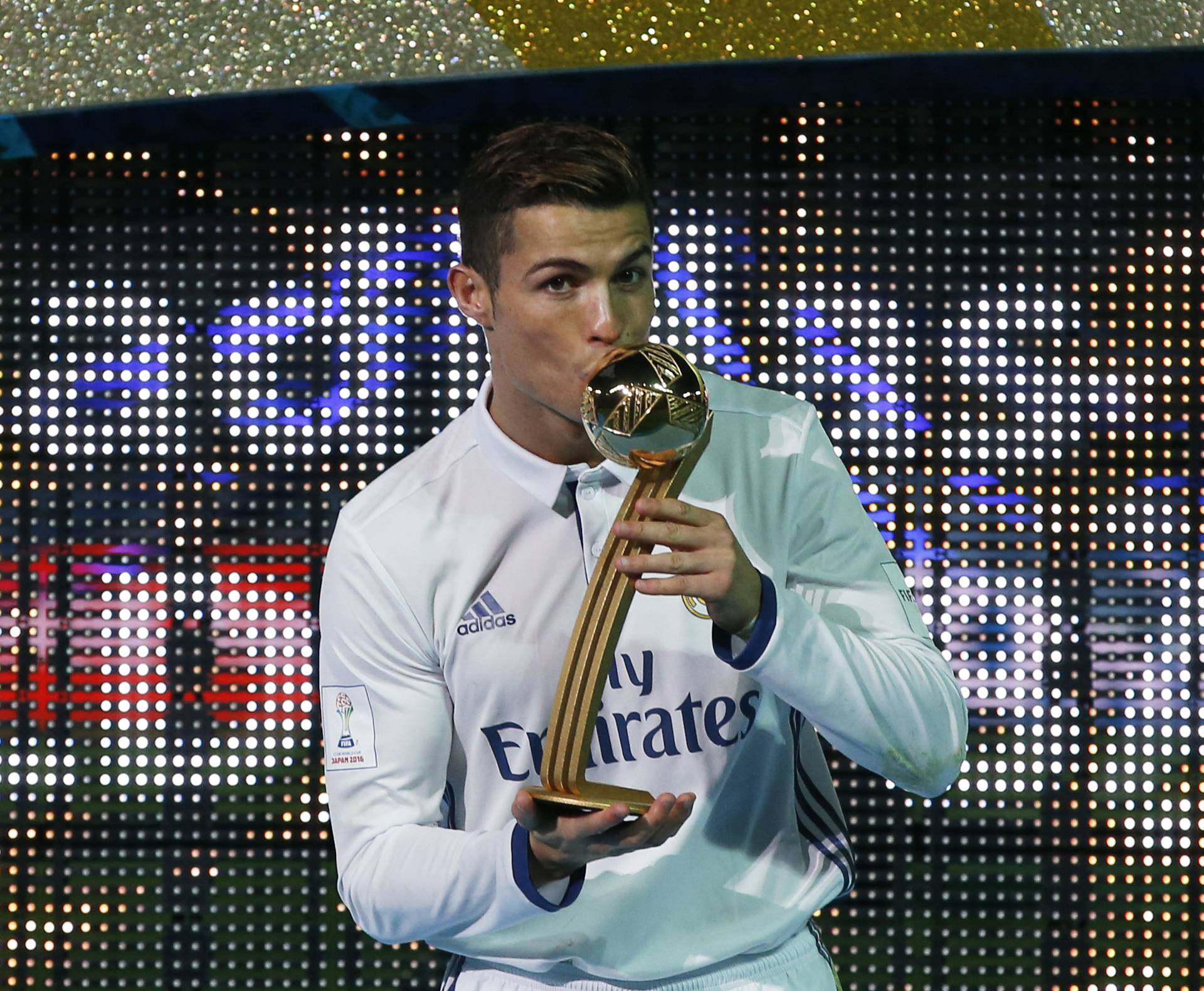 Real Madrid's Cristiano Ronaldo celebrates with the Golden Ball trophy