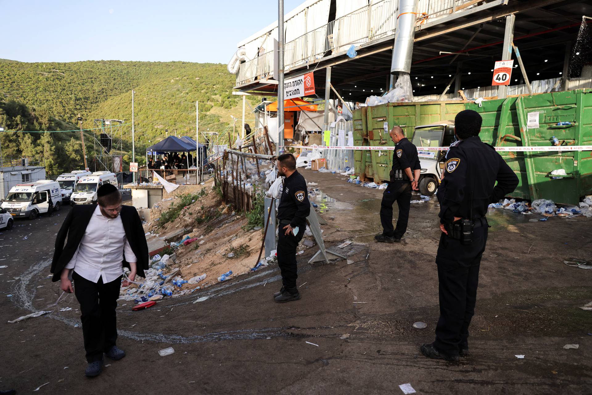 Policemen stand on Mount Meron