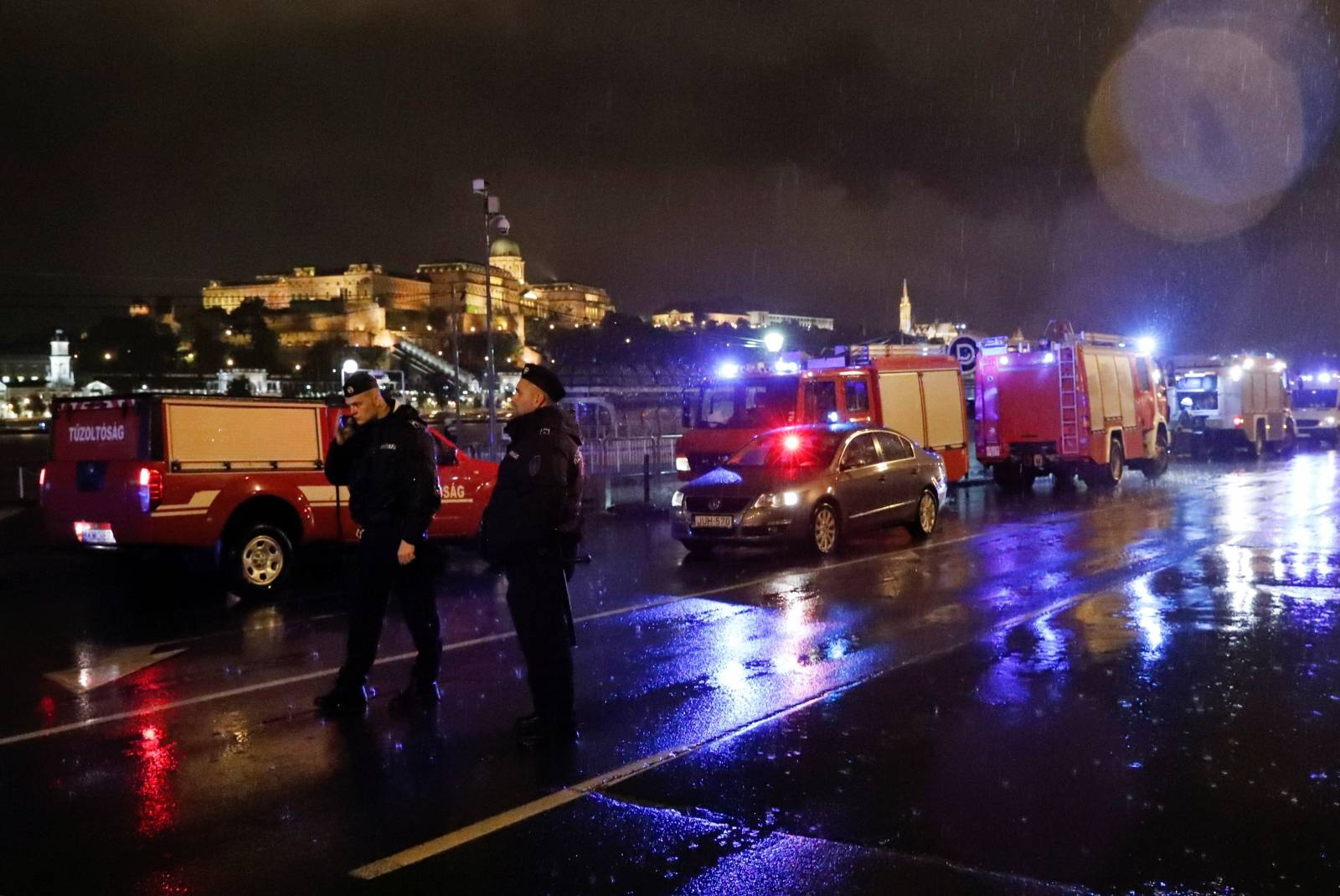Police and fire brigade vehicles are seen on the Danube bank after tourist boat capsized on the riverÂ in Budapest