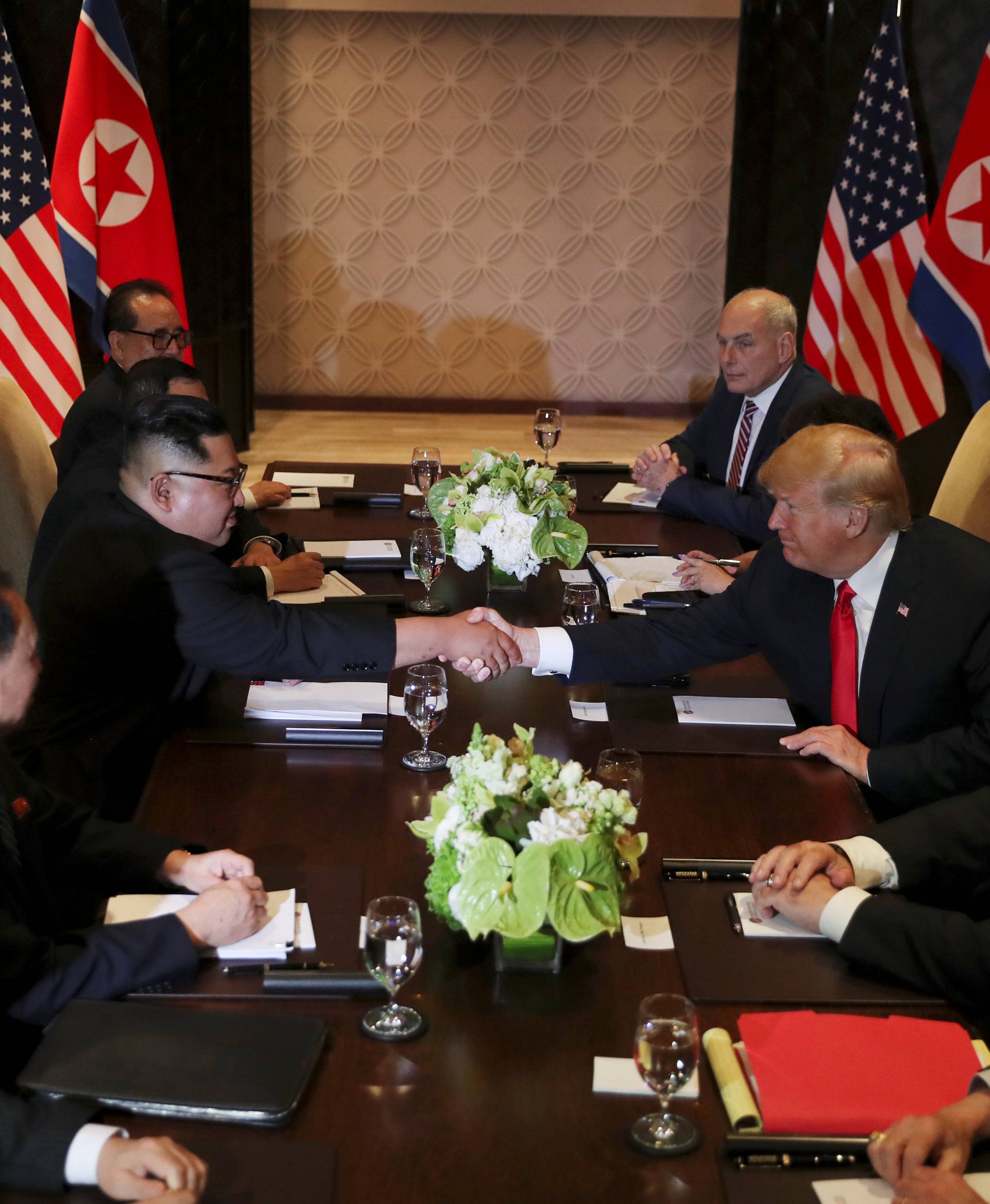 U.S. President Donald Trump shakes hands with North Korea's leader Kim Jong Un before their expanded bilateral meeting in Singapore