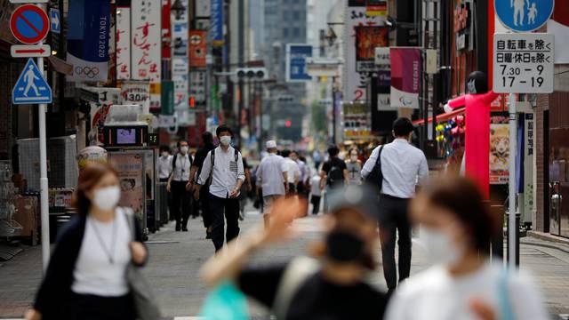 Passersby wearing protective face masks are seen on the street amid the coronavirus disease (COVID-19) outbreak, in Tokyo