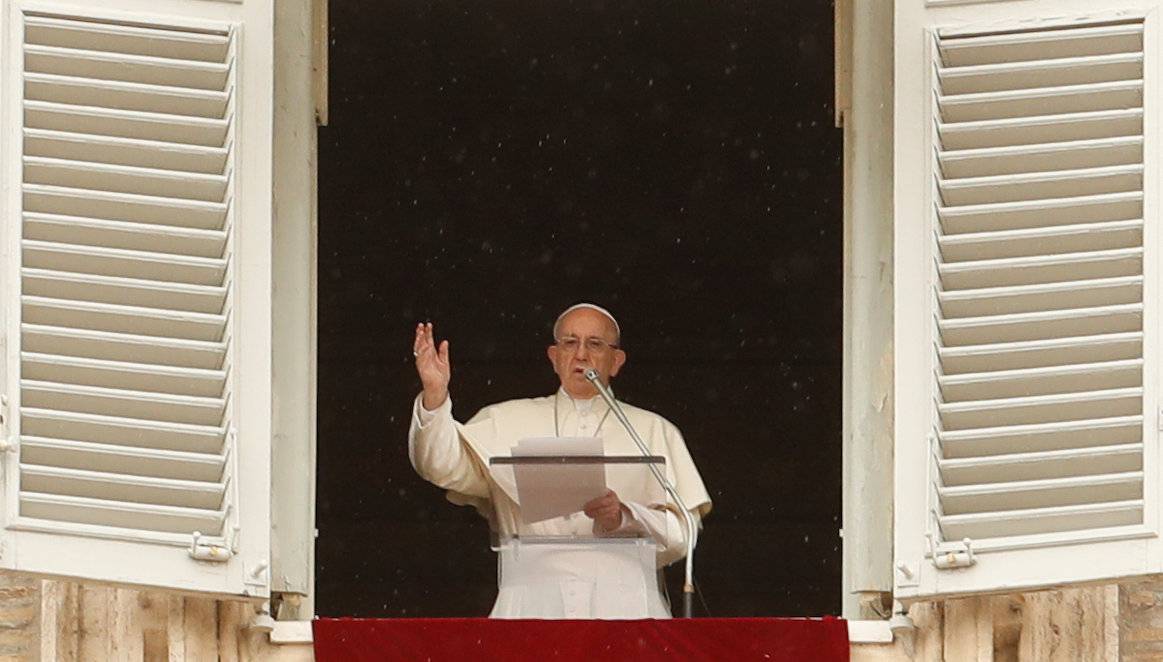 Pope Francis makes a blessing as he arrives for the Angelus prayer in Saint Peter's Square at the Vatican