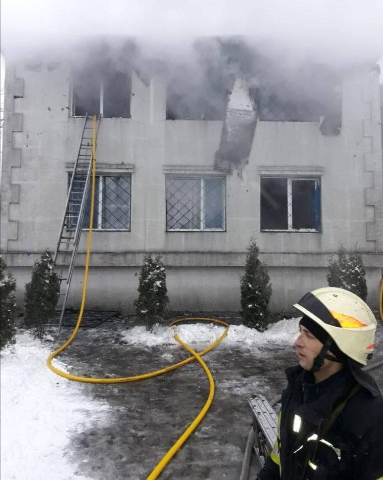 A rescuer works at the scene of the accident following a fire in nursing home in Kharkiv