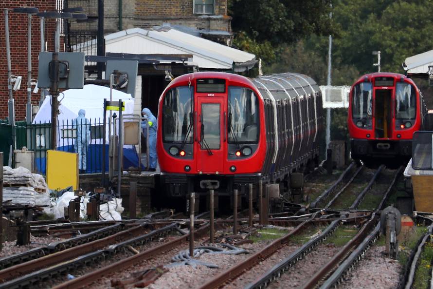 Forensic investigators search on the platform at Parsons Green tube station in London