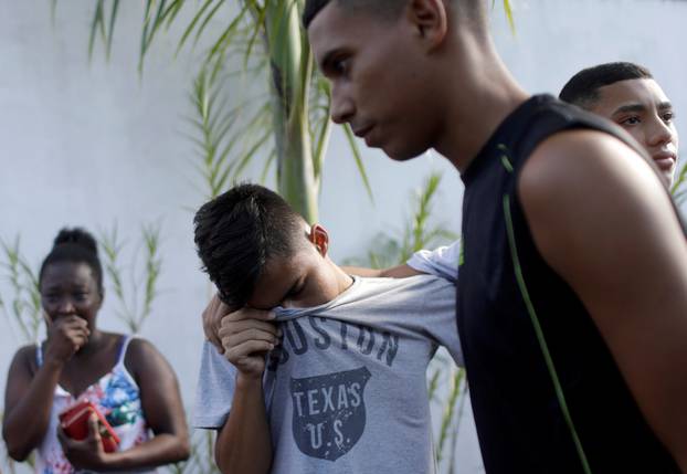 People wait for information at Flamengo training center after deadly fire in Rio de Janeiro