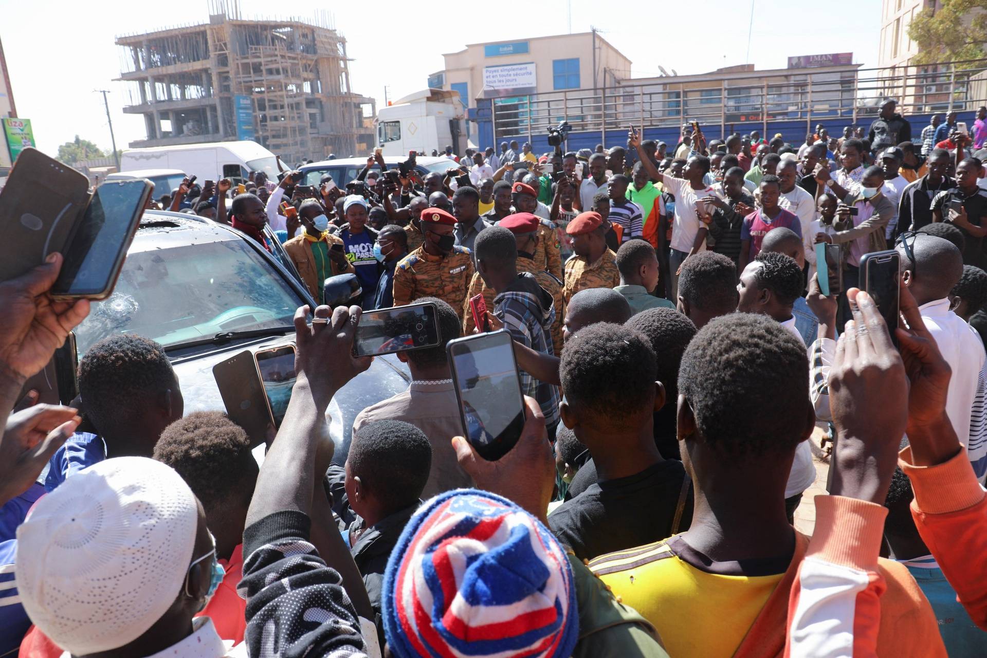 People gather after Burkina Faso President Roch Kabore was detained at a military camp following heavy gunfire near the president's residence in Ouagadougou