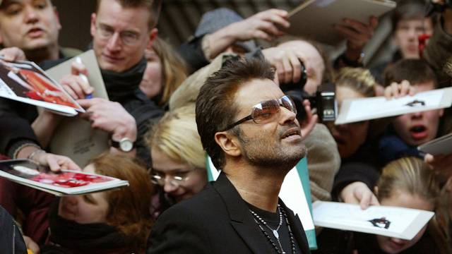 FILE PHOTO British singer and actor George Michael leaves a news conference