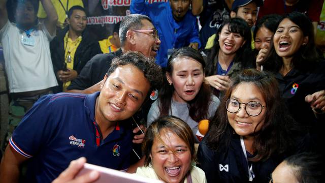 Journalists celebrate after a news conference near Tham Luang cave complex in the northern province of Chiang Rai