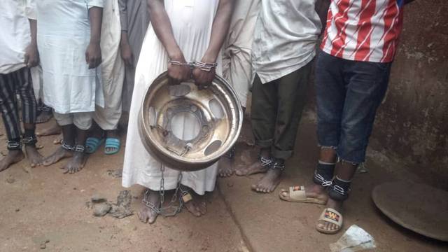 A handout picture from police shows people tied and chained after police raided a house freeing men and boys in Kaduna