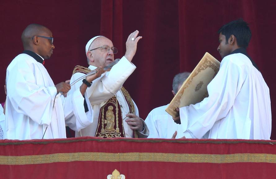 Pope Francis makes a blessing during the "Urbi et Orbi" (to the city and the world) message from the balcony overlooking St. Peter's Square at the Vatican