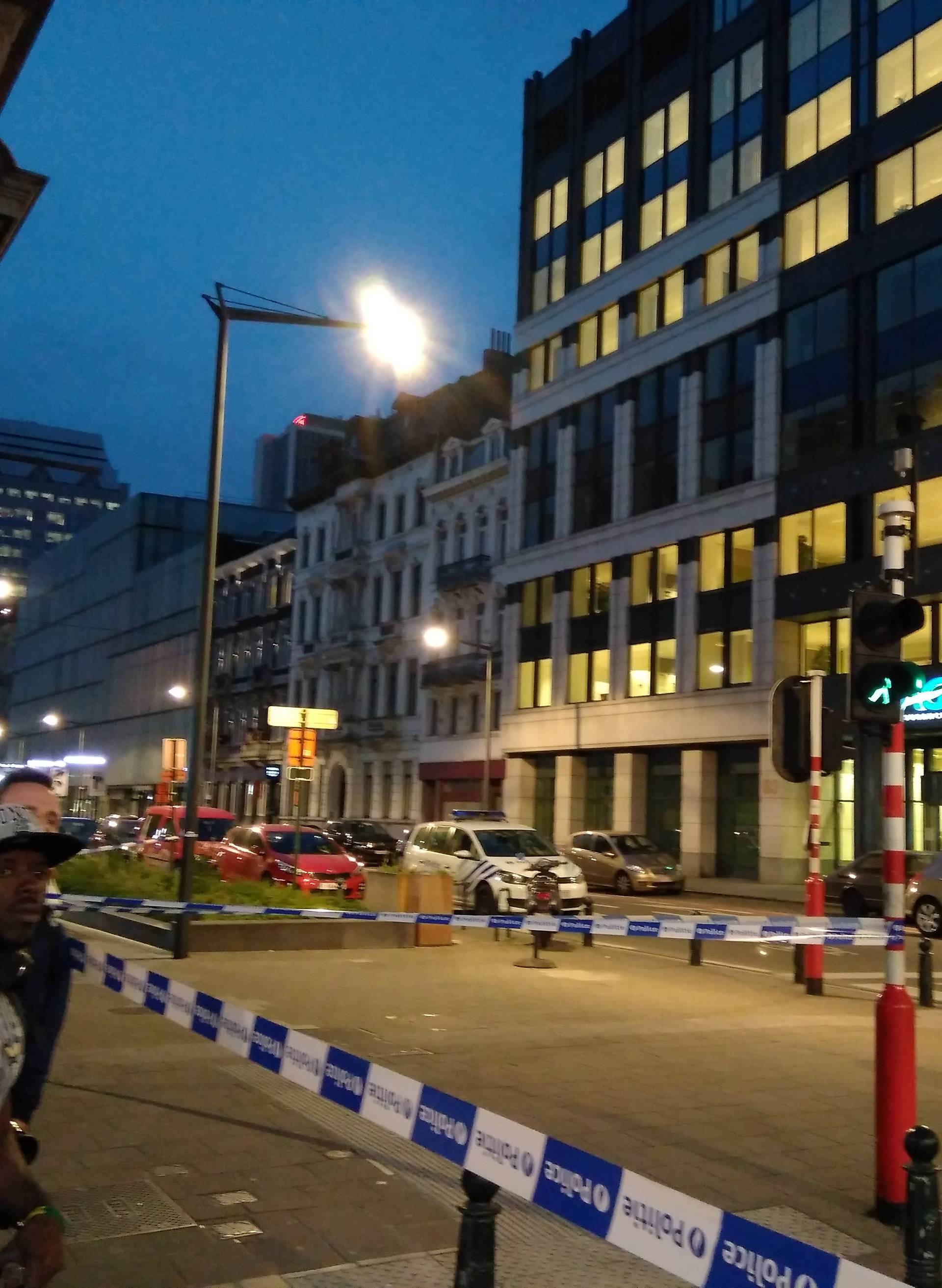 People walk next to the scene where a man attacked two soldiers with a knife in Brussels, Belgium August 25, 2017 in this picture obtained from social media